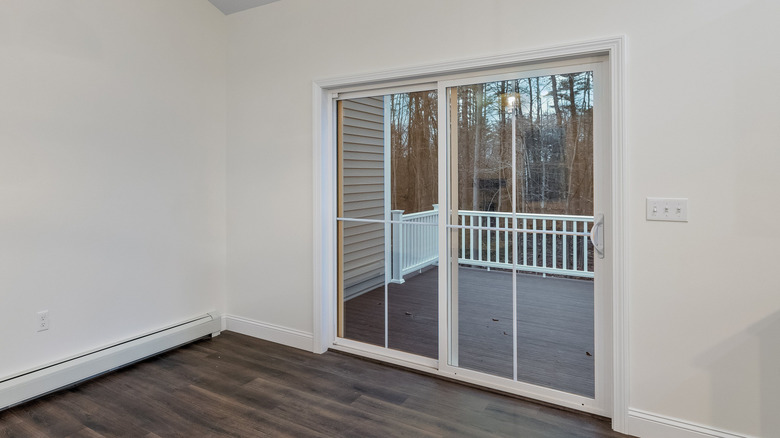 Interior room with a sliding glass door without window treatments