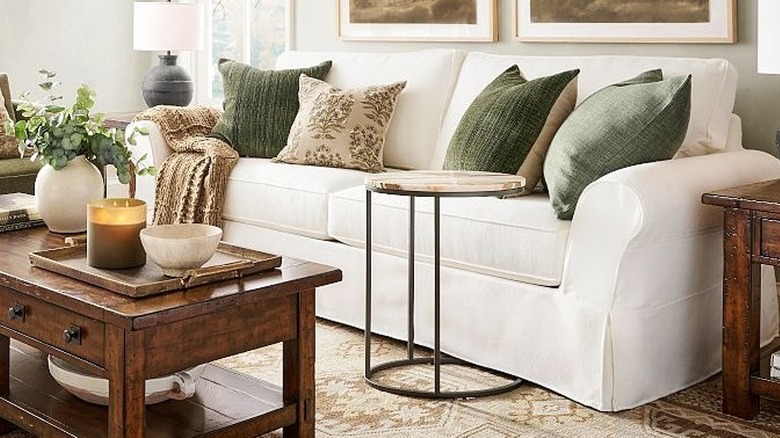 A slipcover sofa in a living room with throw pillows