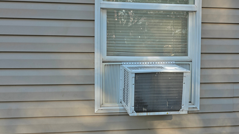 Small air conditioner on the exterior of a house's window