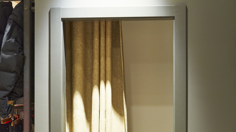 Yellow curtain used as a door in bathroom doorway