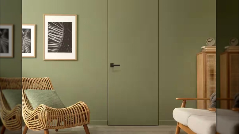 Invisible door against green wall.