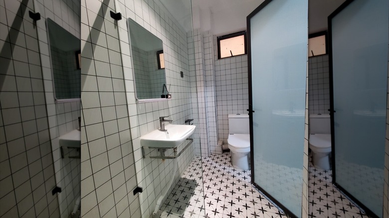 Bathroom with tempered glass pivot door.