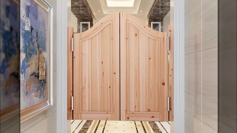 Set of wooden saloon doors on doorframe.