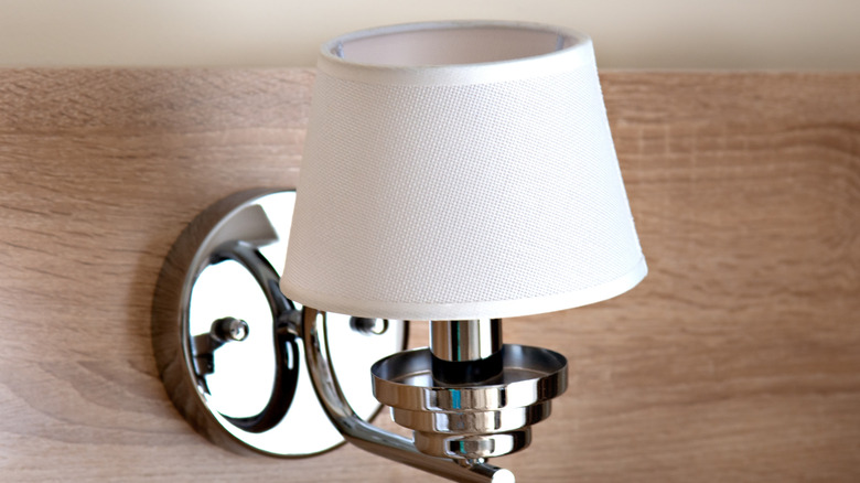 Wall sconce with metal base and white shade