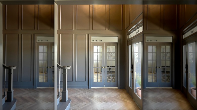 An entryway with molding painted a greige color with a glossy finish