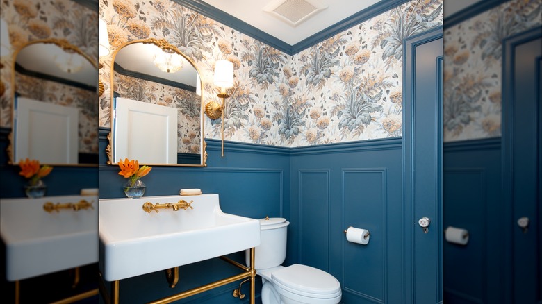 A traditional style, small bathroom with teal wainscoting and wallpaper accents.