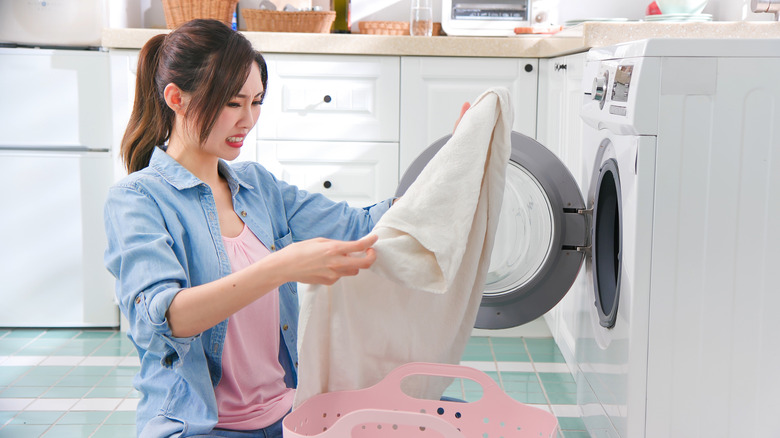 Woman inspects a stained shirt