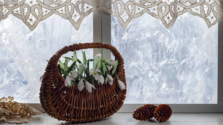 Frosted window with pinecones and basket