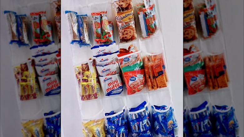 A shoe organizer filled with snacks