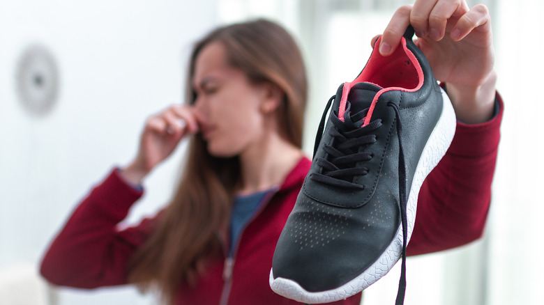 Women holding smelly shoe