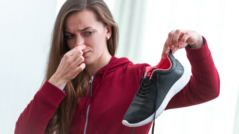 Person holding smelly shoe