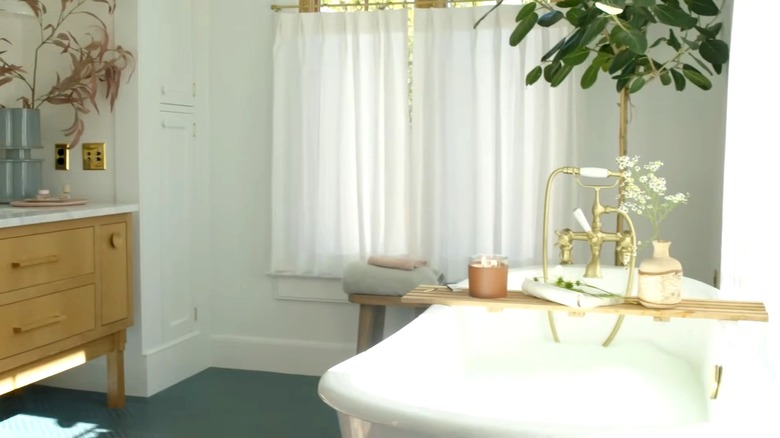 Emily Henderson standing in a bright bathroom.