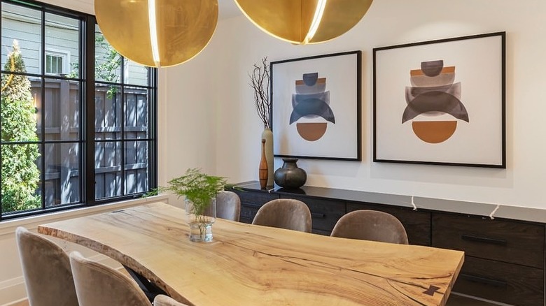 A small dining room with a wood table.