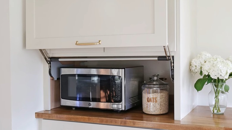 white kitchen with appliance garage containing microwave