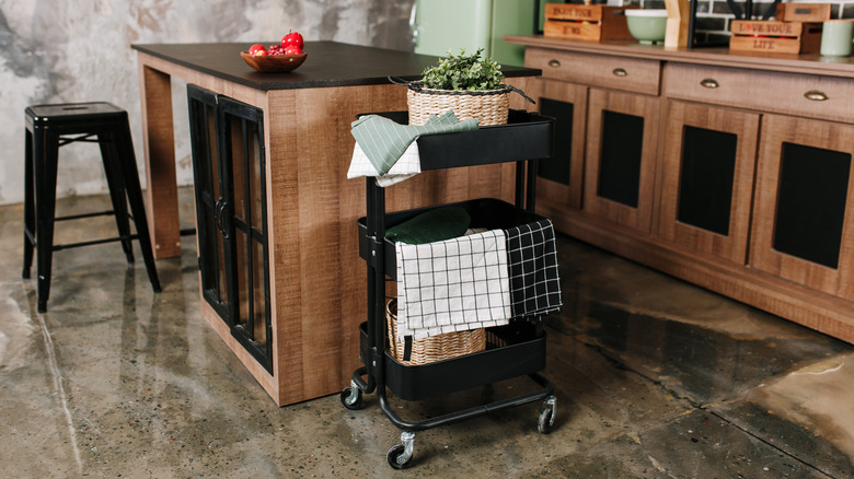 rolling cart in kitchen beside island