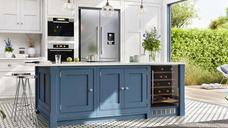 blue kitchen island with cabinets and built-in cooler