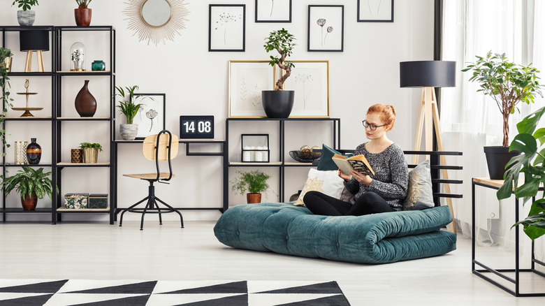 woman sitting on folded futon