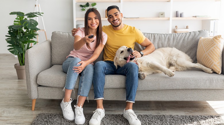 Couple with dog on couch