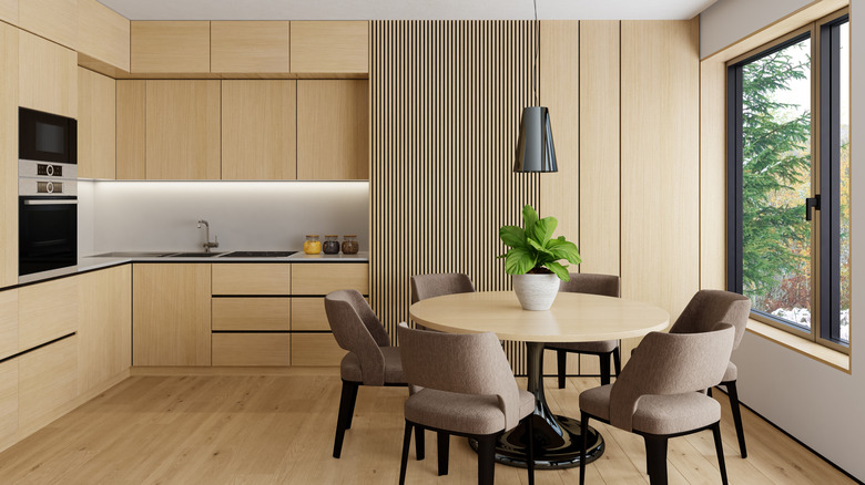 Elegant modern kitchen interior featuring a Scandinavian design with white and pine wood materials.