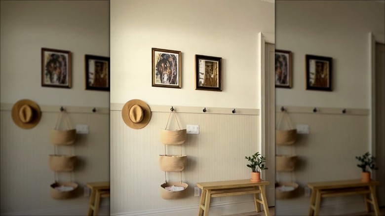 A wall with hooks and hanging baskets