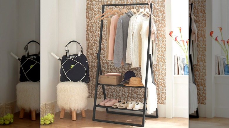 Clothing rack with shelves inside an entryway