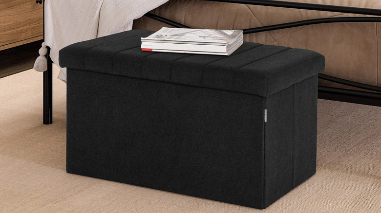 Seville Classics storage trunk with books stacked on top