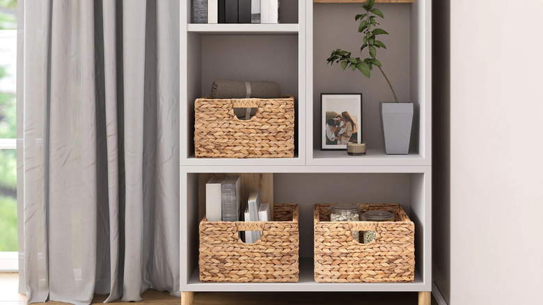 Water hyacinth baskets on a shelf filled with various items
