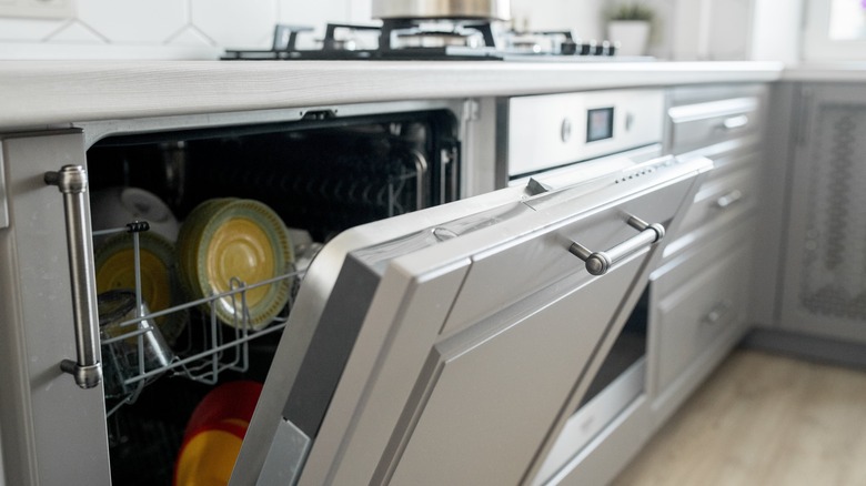 Open dishwasher full of dishes