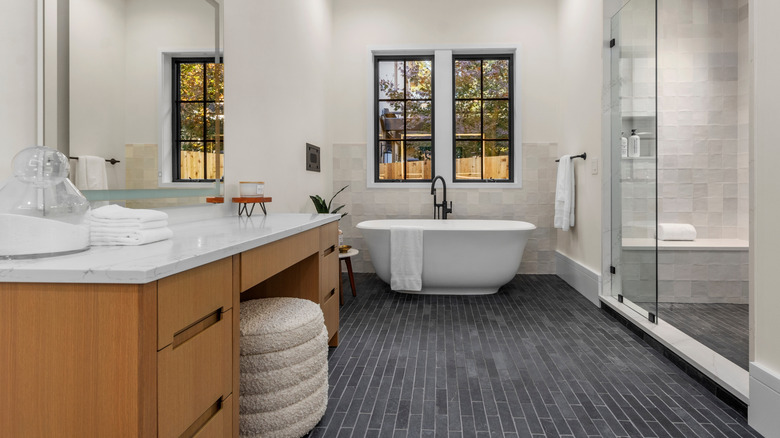 Stylish bathroom with freestanding tub, and custom vanity cabinet