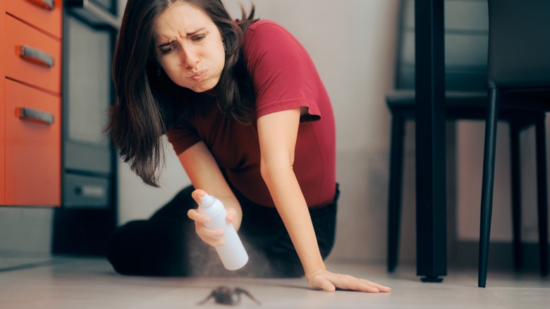 Woman fretting over spider inside home