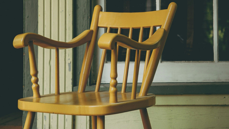 A spindle chair on a porch
