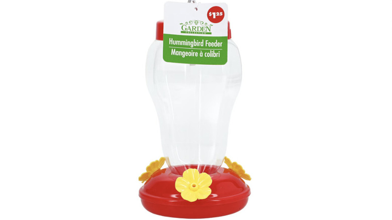 Red and yellow hummingbird feeder against white background