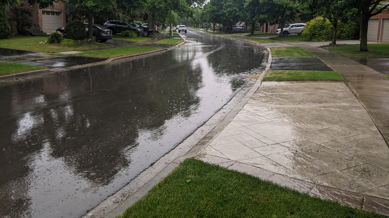Water runoff in the road during a rainy day in a suburban neighborhood