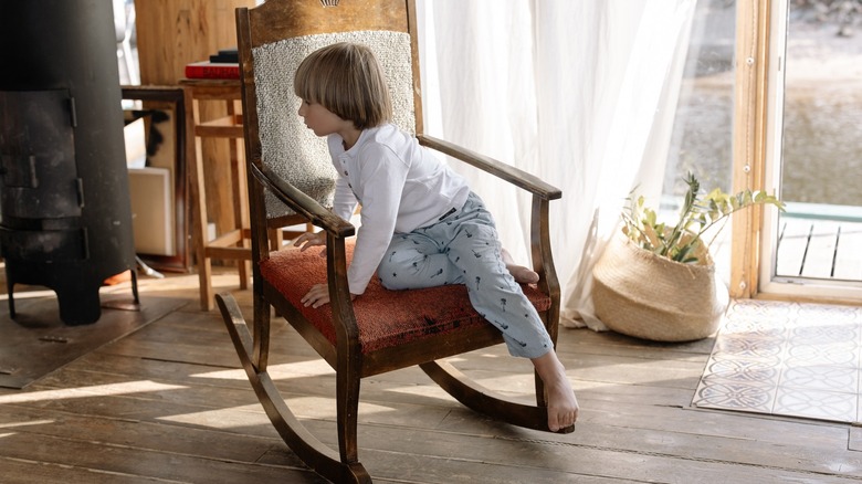 child playing on rocking chair