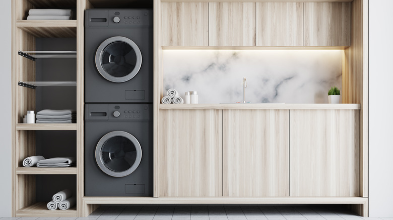 Stacked black washer and dryer