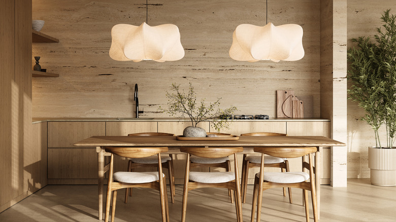 khaki and wood neutral dining room layout with modern table and dramatic pendant lights