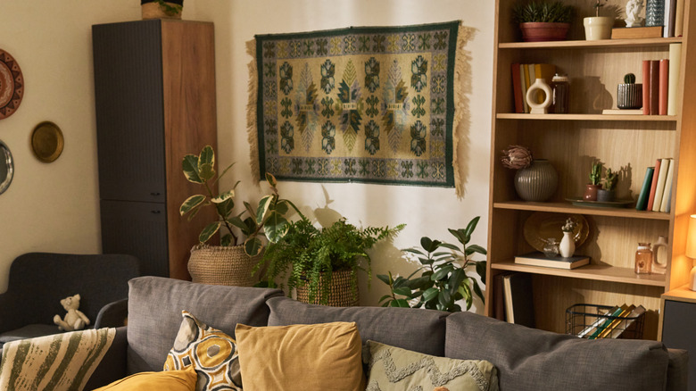 Modern living room with a medium sized wall tapestry hung behind the sofa