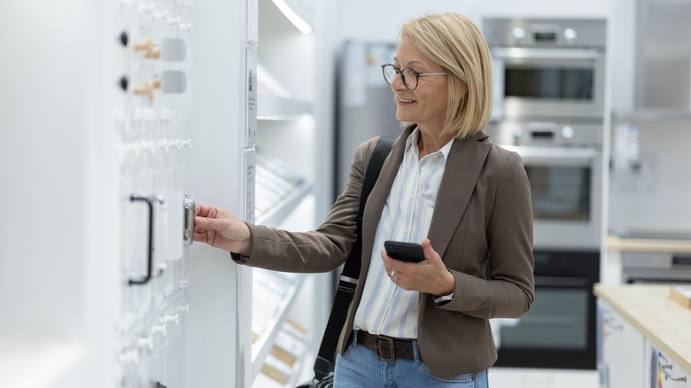 A woman shopping for cabinet hardware.