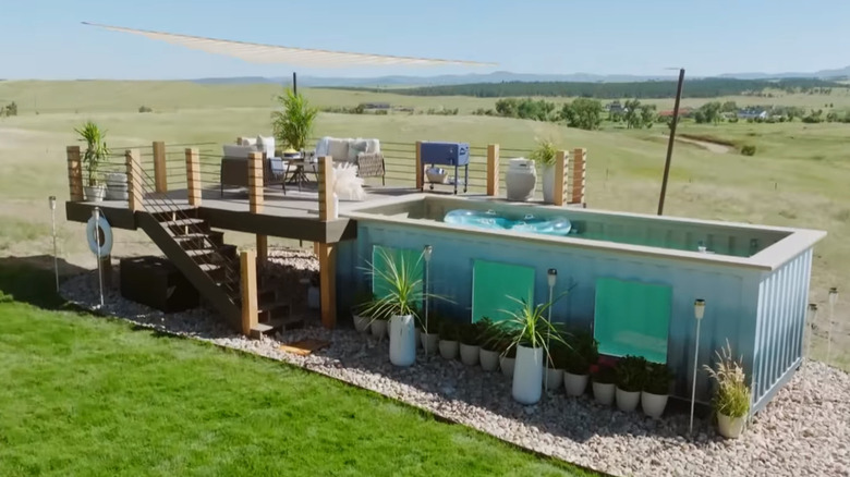 A container pool above  ground with windows and a deck