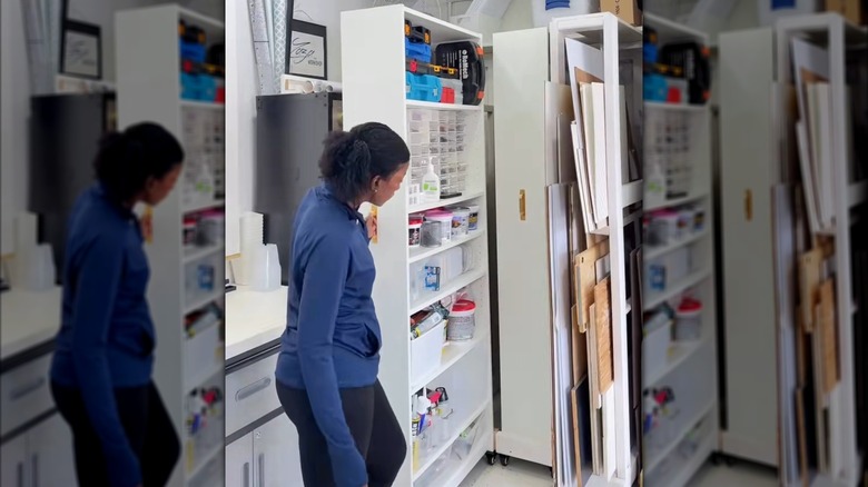 Woman pulling out Ikea BILLY cabinet on wheels