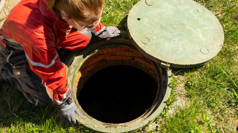 woman opening manhole