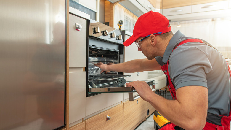A technician working on a new oven
