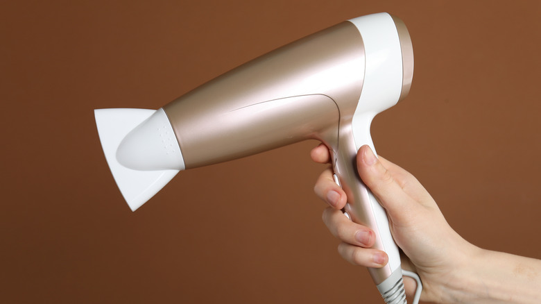 Close up of hair dryer on brown background