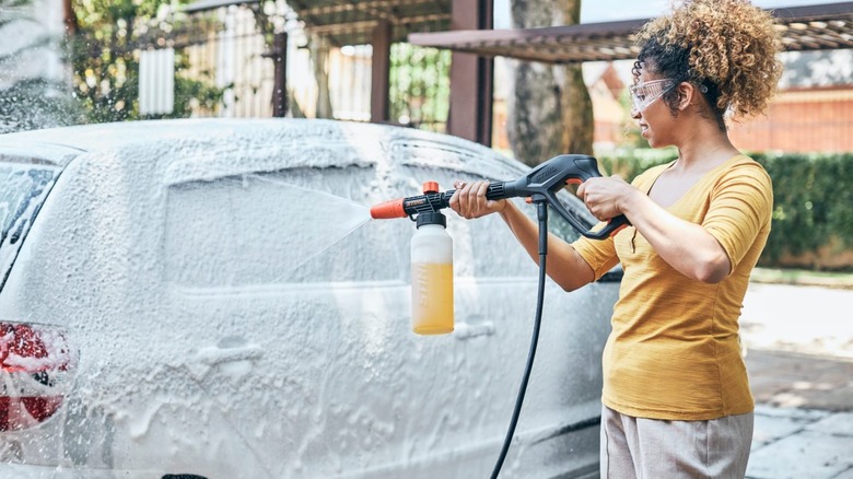 A person cleaning their car with Stihl's Foam Nozzle pressure washer attachment