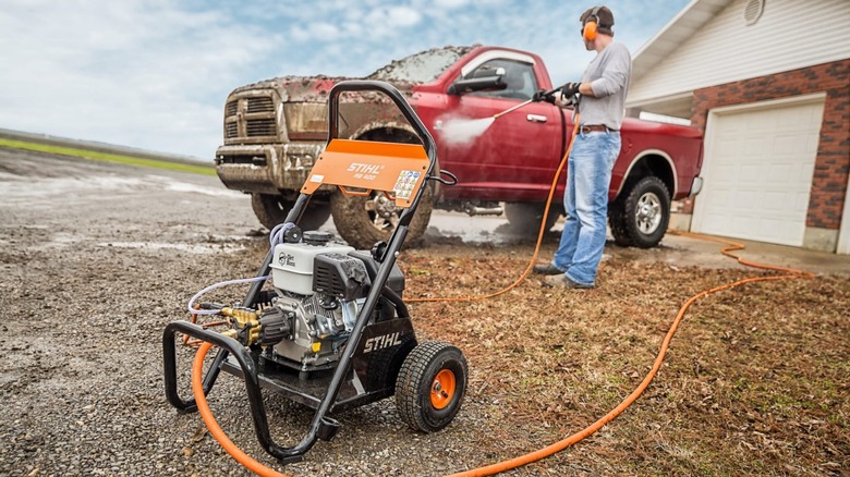 A person cleaning a car with Stihl's RB 400 Dirt Boss pressure washer