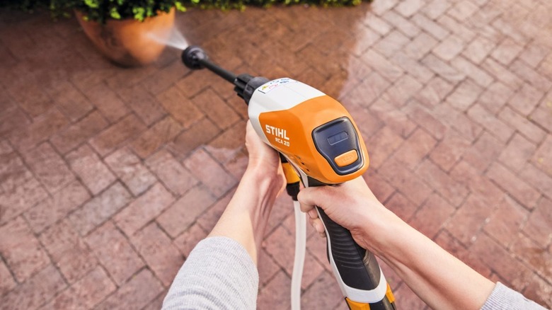 A person using Stihl's RCA 20 pressure washer