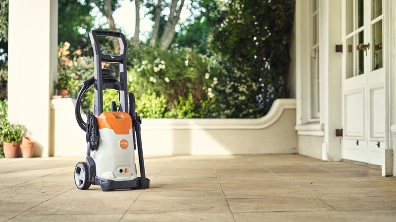 Stihl's RE 90 Plus Corded Electric Pressure Washer on a front porch