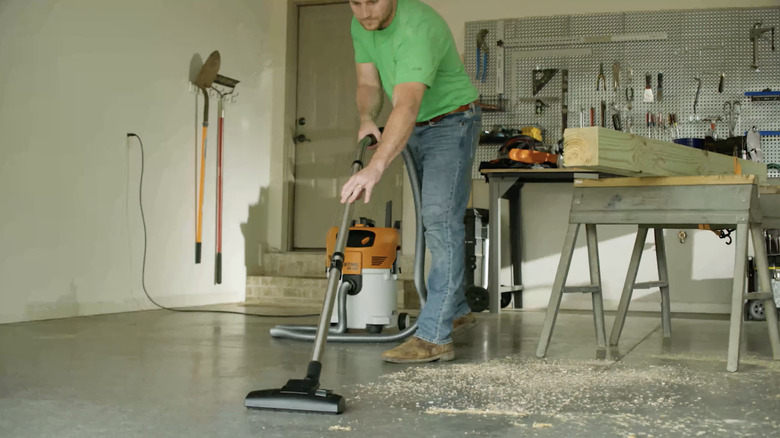 A person cleaning a floor with Stihl's SE 122 Electric Wet/Dry Vacuum