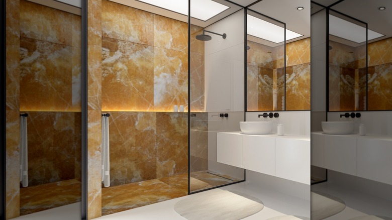 A bathroom with marble walls in the shower