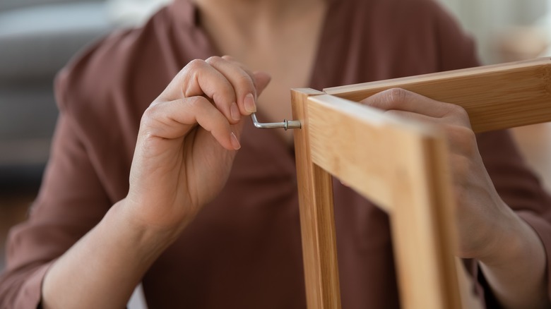 Woman using allen wrench